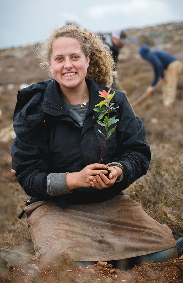 Girl plants tree on Tu B'Shvat