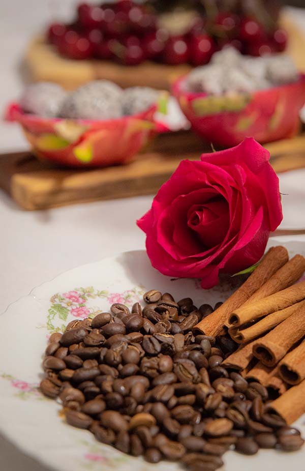 Tu B'Shvat seder plate with roses, cinnamon and coffee